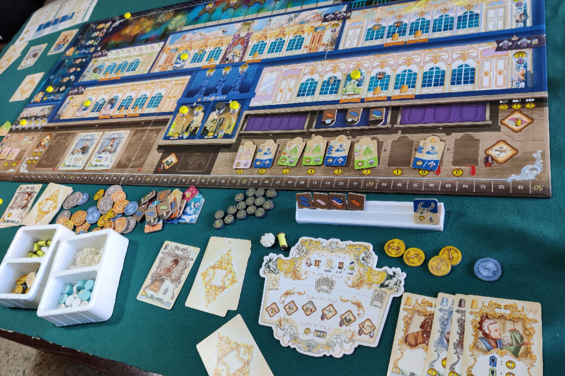 Game tokens and scenario materials arranged on a table with atmospheric lighting